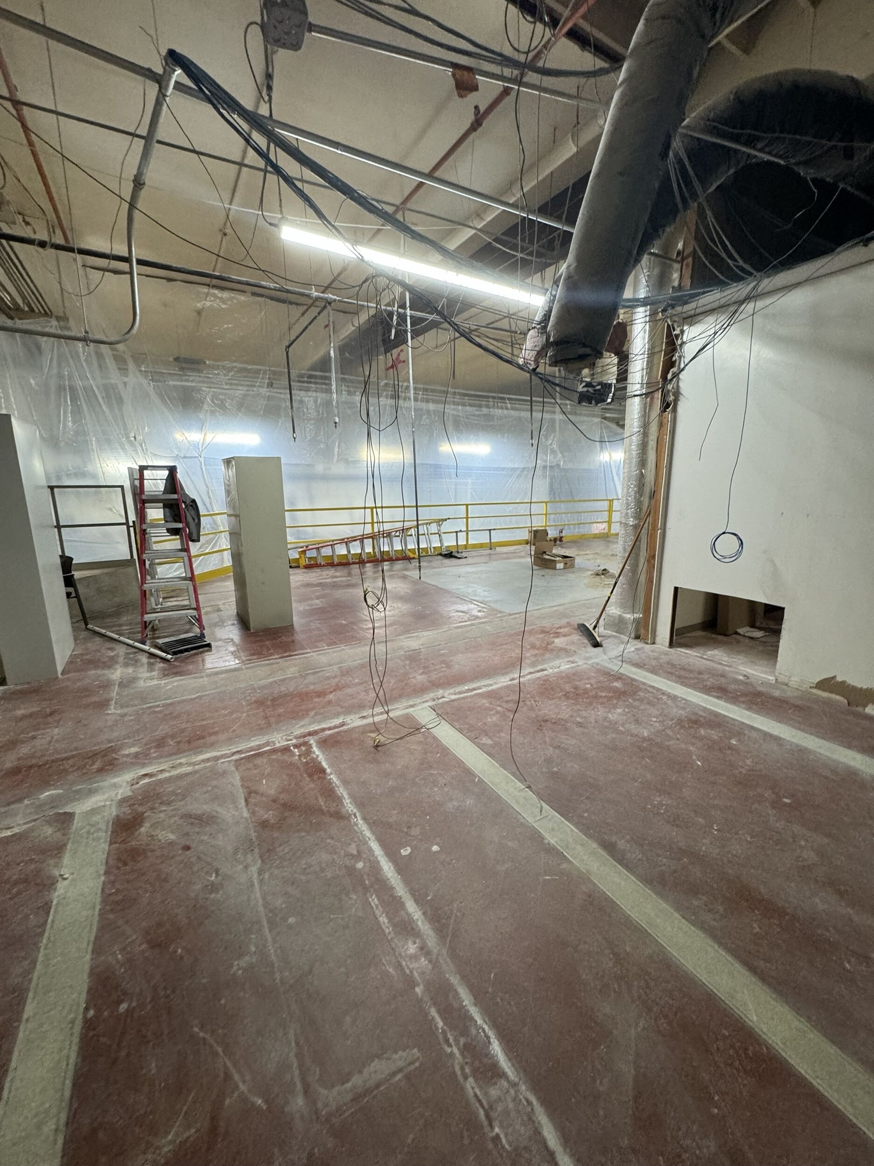 Commercial demolition area with exposed overhead services