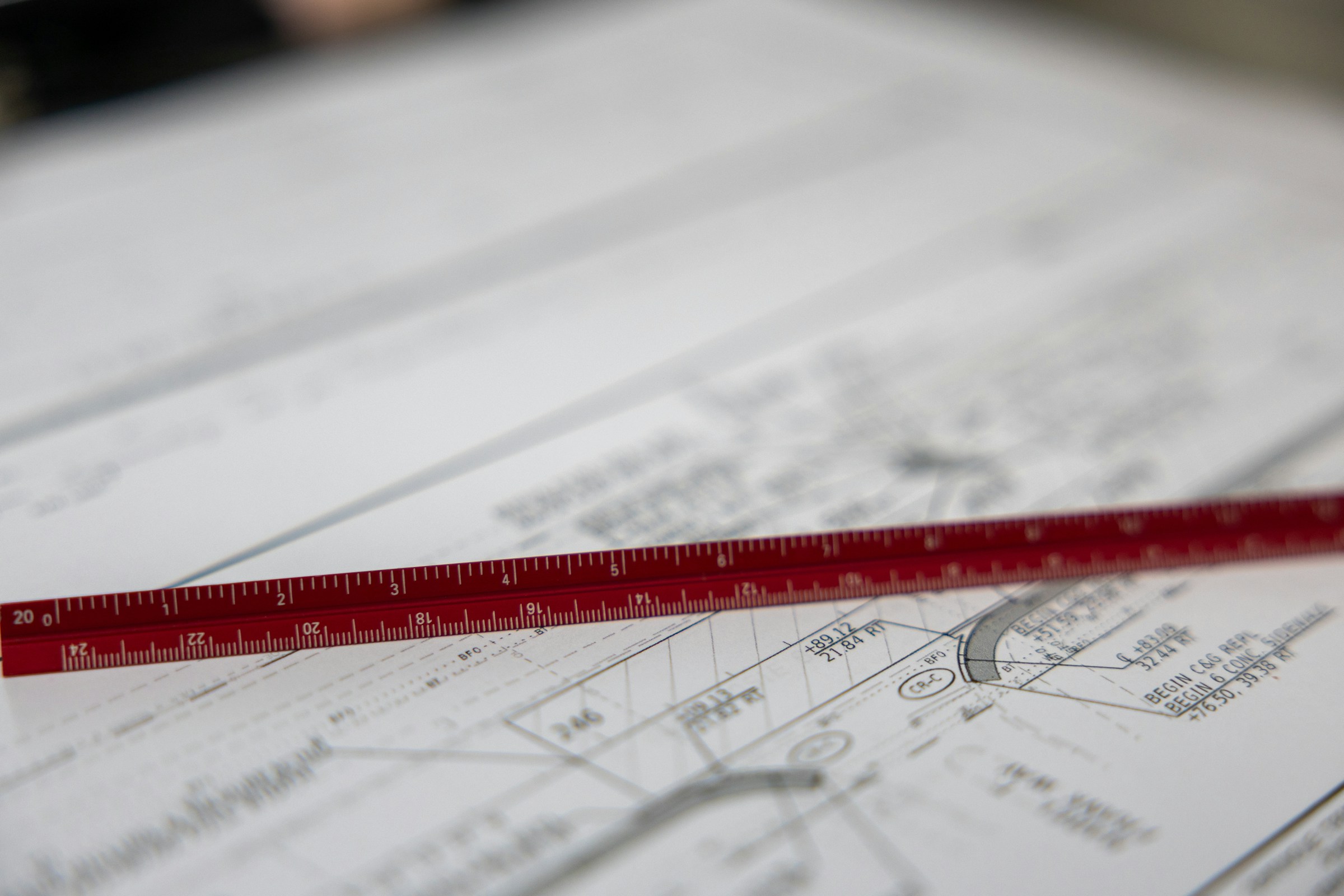 A measuring scale resting on an architectural drawing